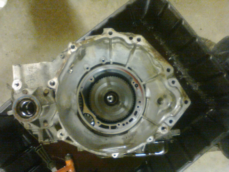 Front pump out (also to be removed: that little cooler bypass valve near the upper-right corner of where the pump was, where you see some ATF pooling)